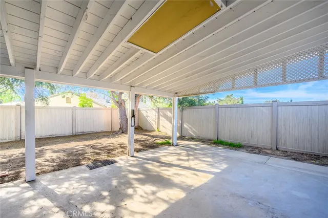 a view of backyard with wooden fence