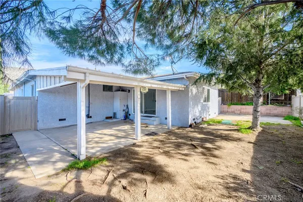 a view of a house with a yard and tree s