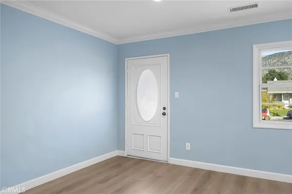 an empty room with windows and mirror