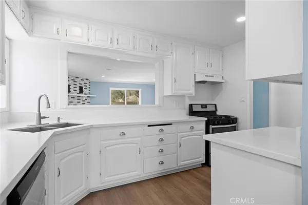 a kitchen with sink and cabinets