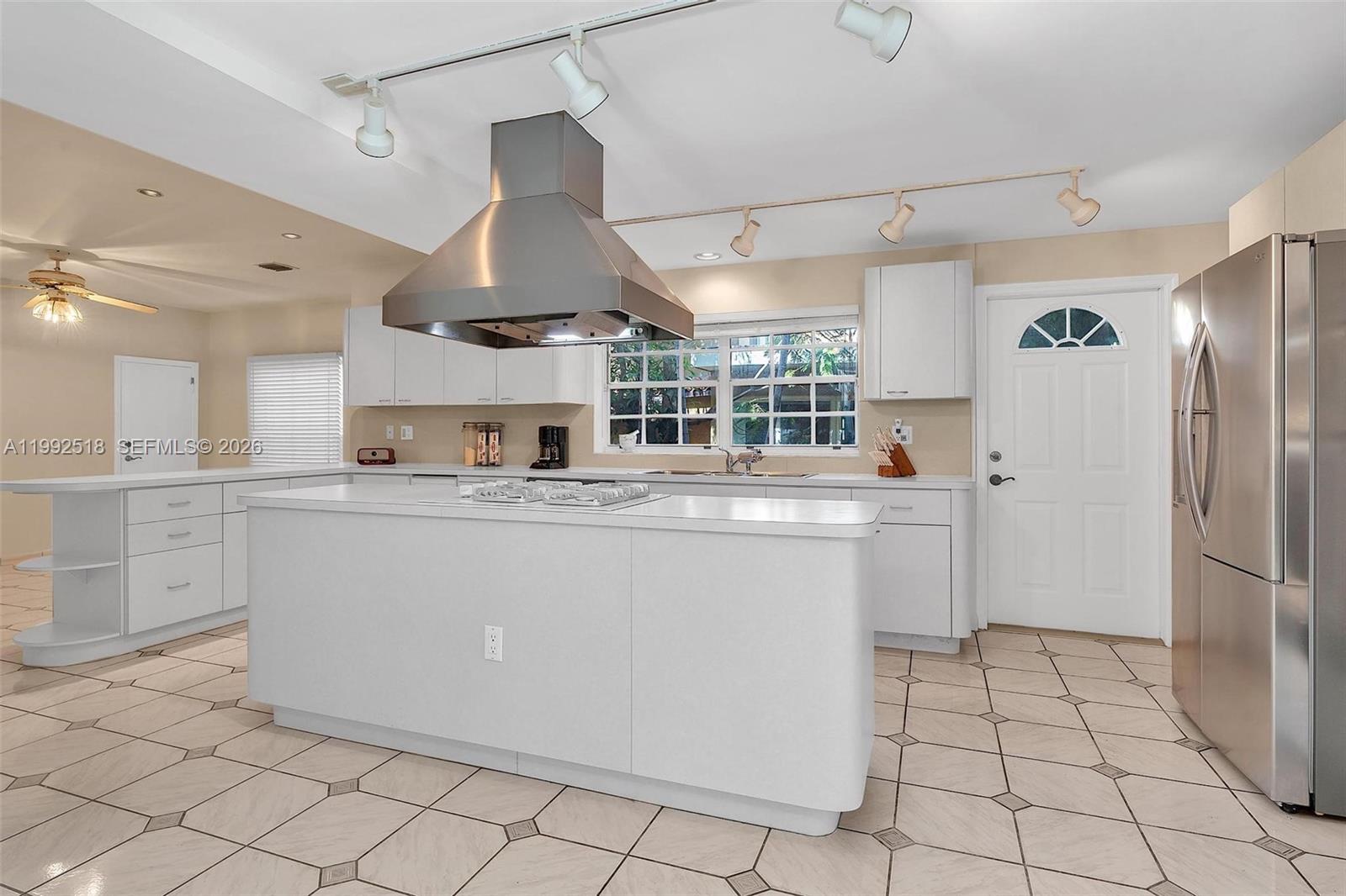 5309 Alton Road Miami Beach, FL 33140 - Photo 10 of 51 a kitchen with stainless steel appliances granite countertop a refrigerator and a stove top oven