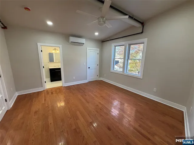 a bathroom with a sink vanity granite tub and a mirror