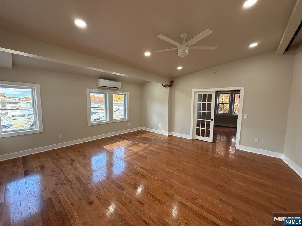 24-30 Pleasant, Unit 2 EAST Maywood, NJ 07607 - Photo 9 of 13 a view of an empty room with wooden floor and a window