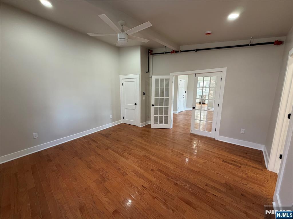 24-30 Pleasant, Unit 2 EAST Maywood, NJ 07607 - Photo 10 of 13 an empty room with wooden floor and windows