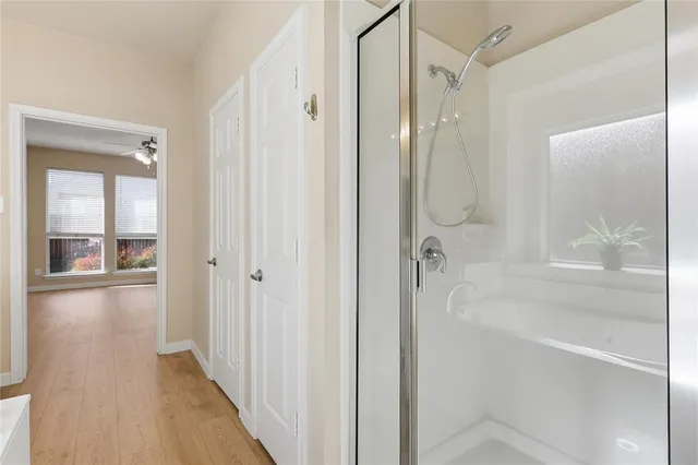 a bathroom with a glass shower door