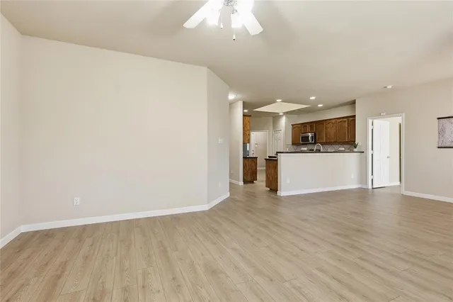 a view of a kitchen with a sink and white cabinets