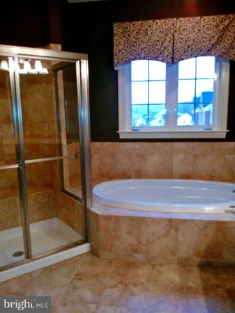 a spacious bathroom with a sink and a mirror