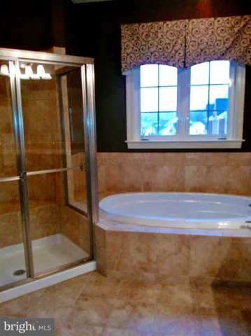 a spacious bathroom with a sink and a mirror