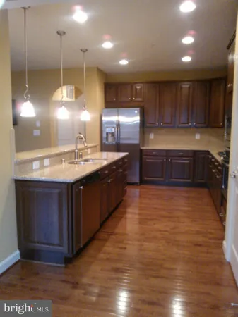a kitchen with kitchen island a sink stainless steel appliances and cabinets