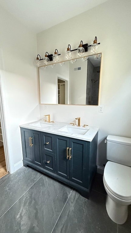 16 Harriet Street, Unit 1 Boston, MA 02135 - Photo 14 of 29 a bathroom with a sink vanity and mirror