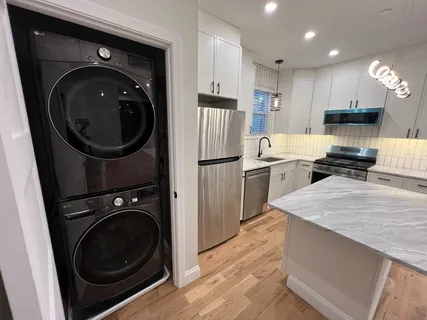 a kitchen with a washer and dryer