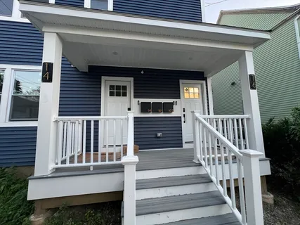 a view of a house with large windows and stairs