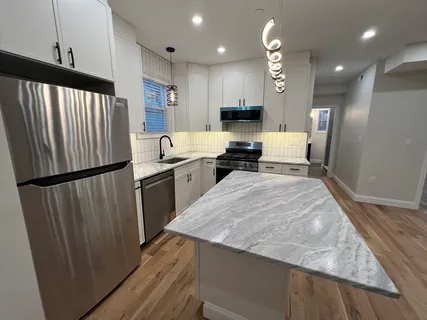 a kitchen with stainless steel appliances granite countertop refrigerator sink and cabinets