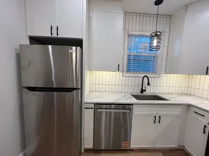 a kitchen with a sink and a refrigerator