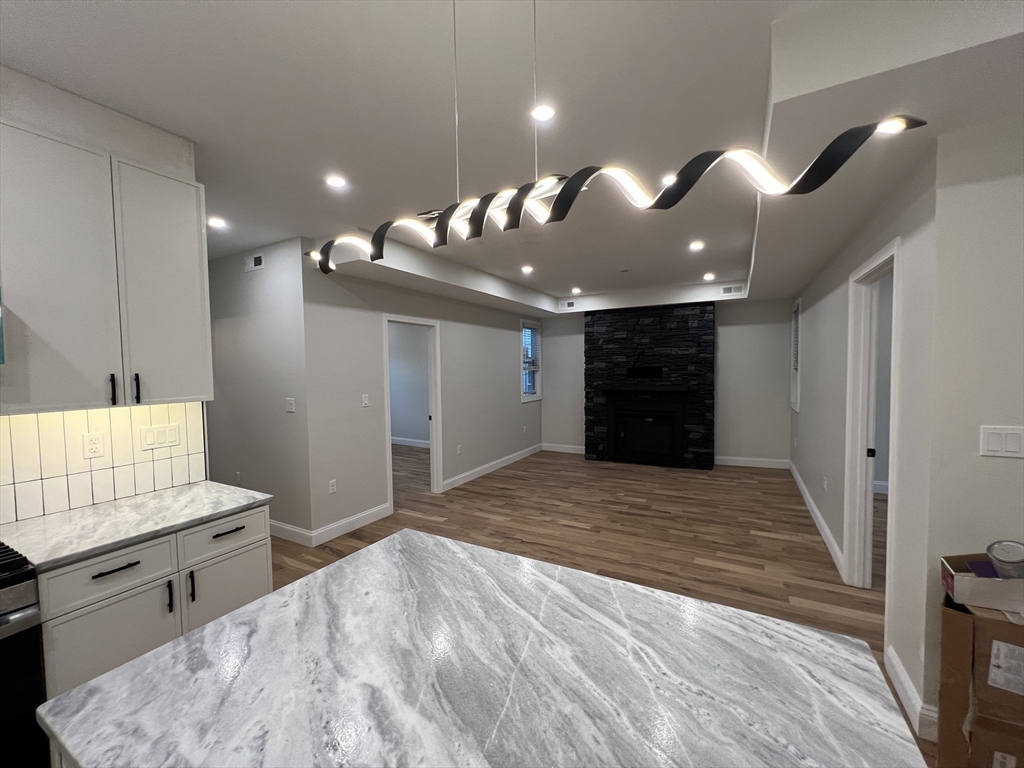 16 Harriet Street, Unit 1 Boston, MA 02135 - Photo 6 of 29 a view of an empty room and kitchen view