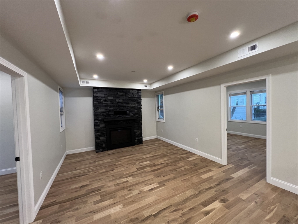 16 Harriet Street, Unit 1 Boston, MA 02135 - Photo 7 of 29 a view of an empty room with wooden floor