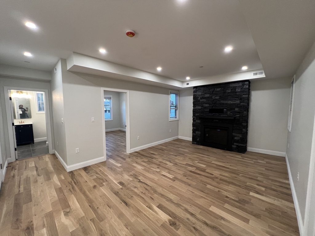 16 Harriet Street, Unit 1 Boston, MA 02135 - Photo 8 of 29 a view of an empty room with wooden floor and closet