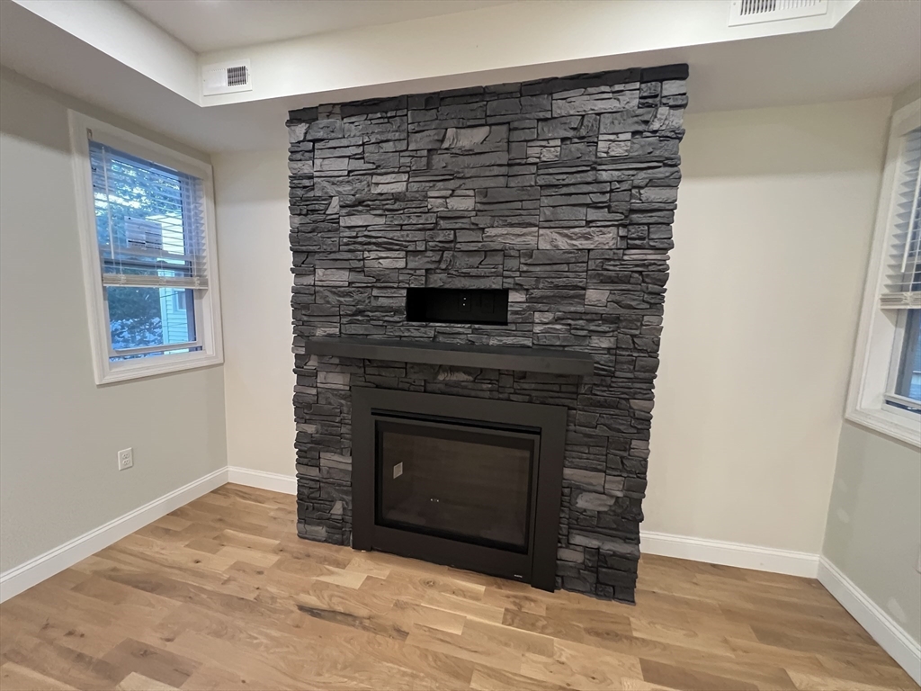 16 Harriet Street, Unit 1 Boston, MA 02135 - Photo 9 of 29 a view of an empty room with wooden floor and a window