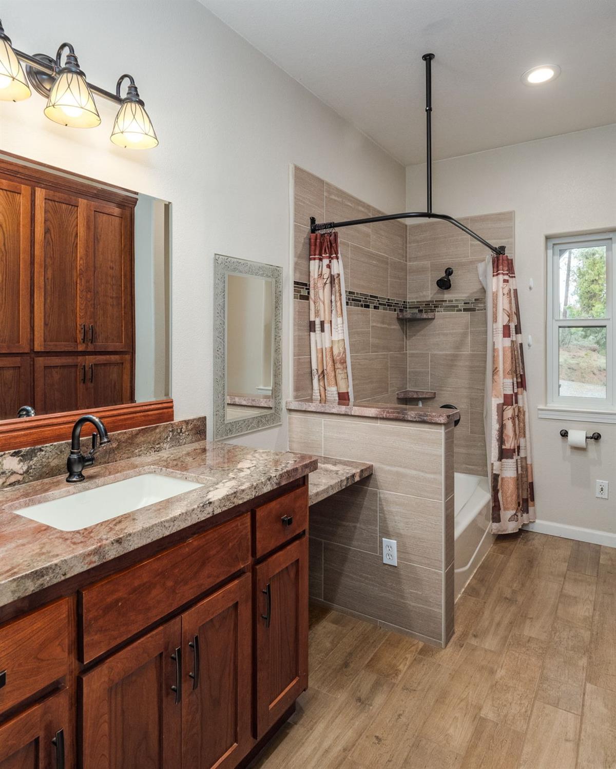 9080 El Dorado Trail Mountain Ranch, CA 95246 - Photo 35 of 48 a bathroom with a sink and a mirror