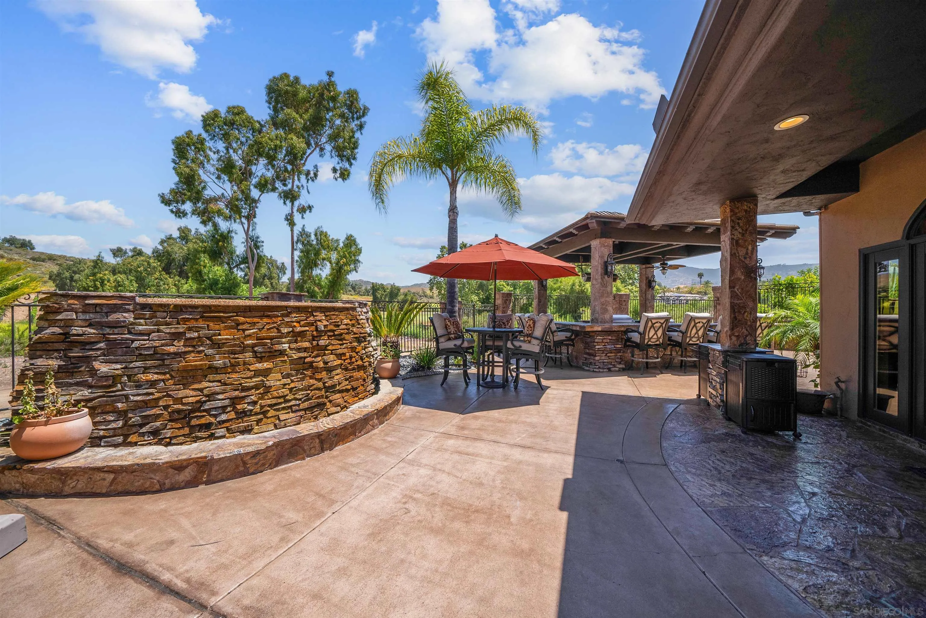 3307 Wentworth Drive Jamul, CA 91935 - Photo 61 of 75 a view of a patio with a table and chairs under an umbrella