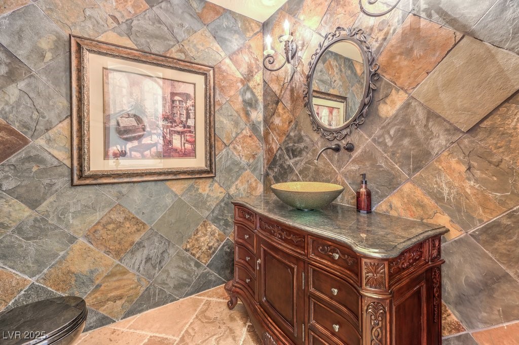 2780 El Camino Road Las Vegas, NV 89146 - Photo 39 of 91 Bathroom featuring vanity, tile walls, and stone tile floors