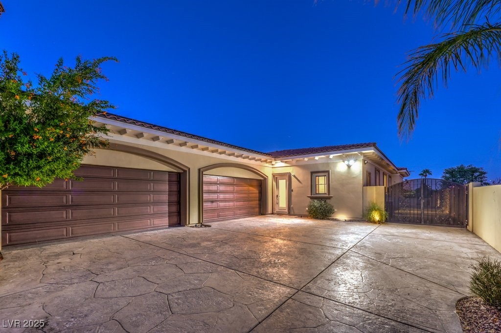 2780 El Camino Road Las Vegas, NV 89146 - Photo 4 of 91 Mediterranean / spanish house with a gate, driveway, stucco siding, and an attached garage