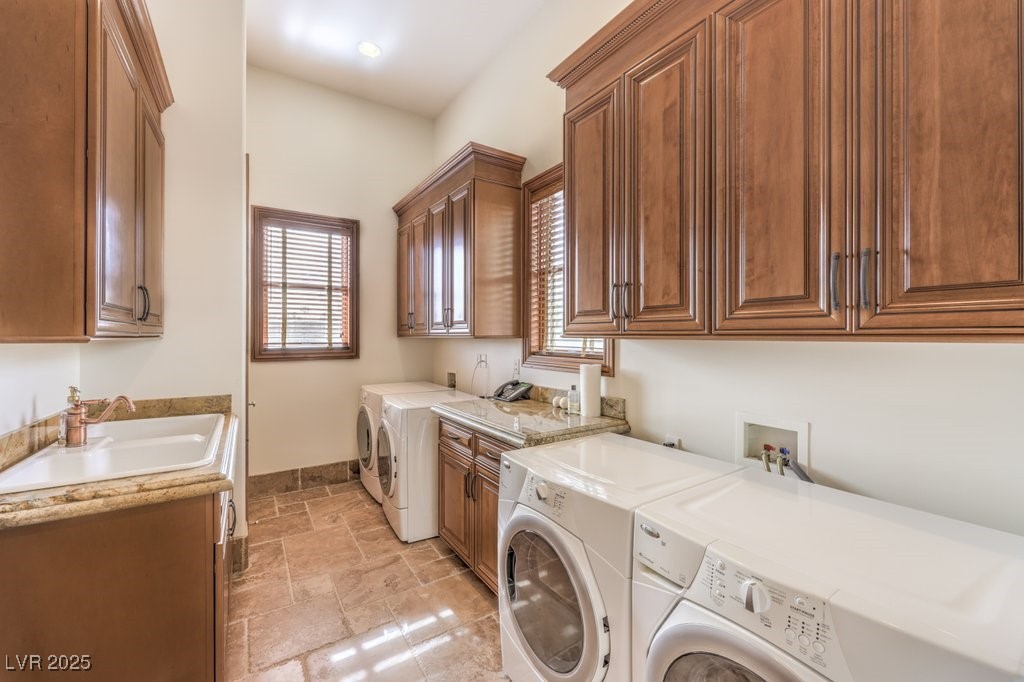 2780 El Camino Road Las Vegas, NV 89146 - Photo 63 of 91 Washroom with washer and clothes dryer, stone tile floors, and cabinet space