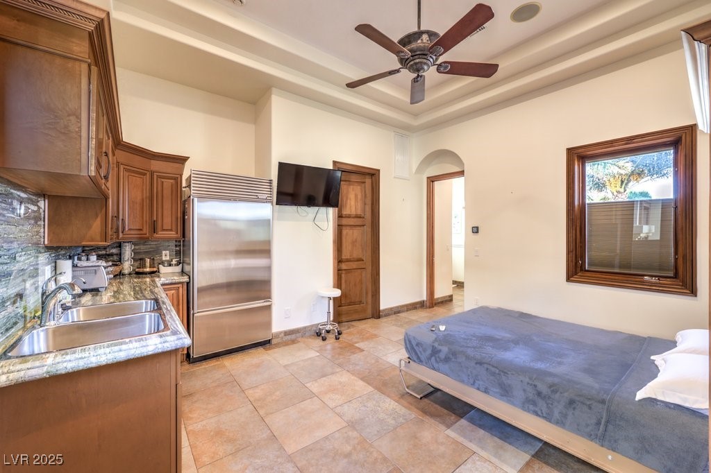 2780 El Camino Road Las Vegas, NV 89146 - Photo 64 of 91 Casita featuring built in fridge, arched walkways, a raised ceiling, and ceiling fan
