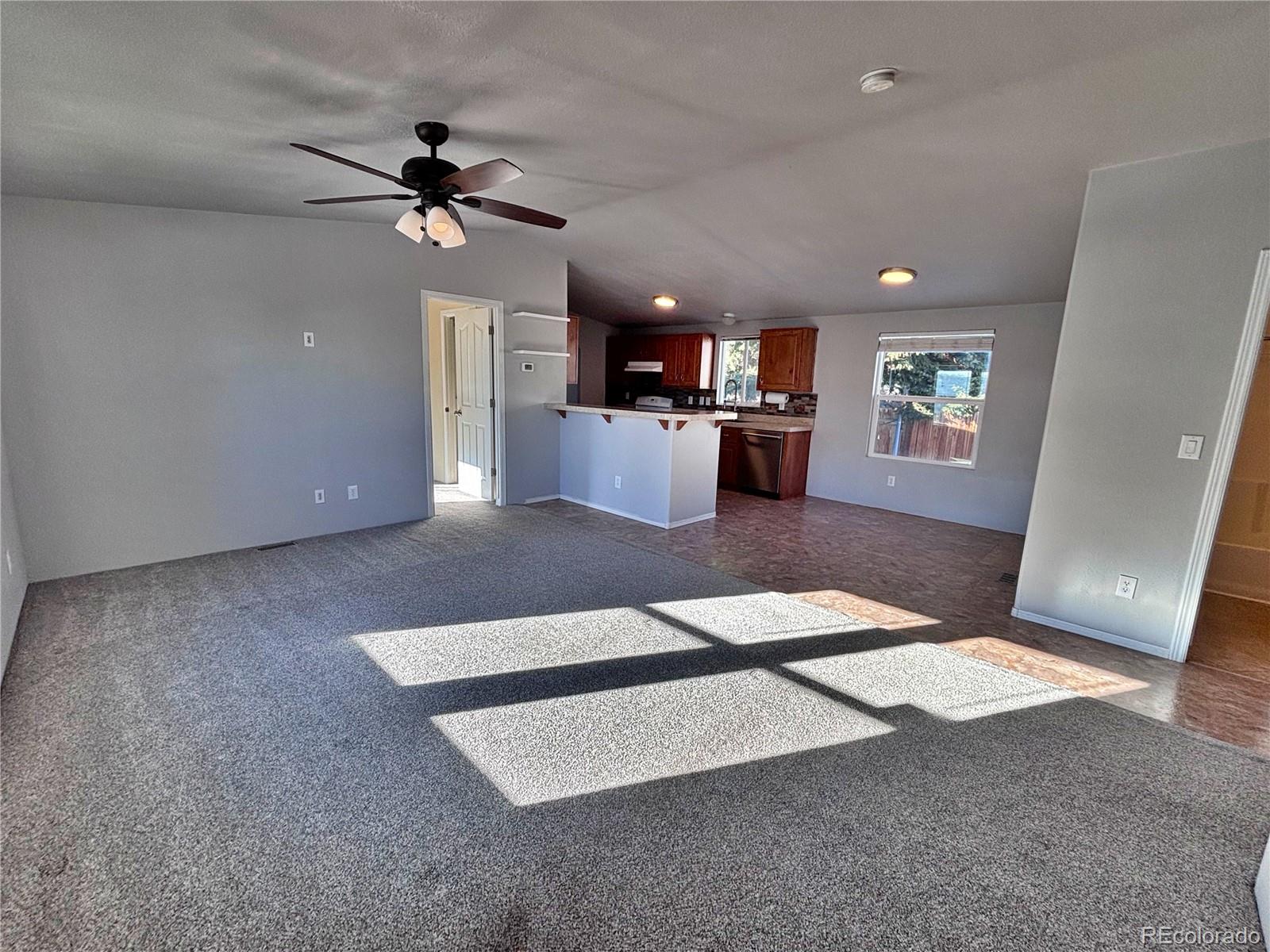155 A Street Golden, CO 80401 - Photo 12 of 49 a living room with furniture and a chandelier