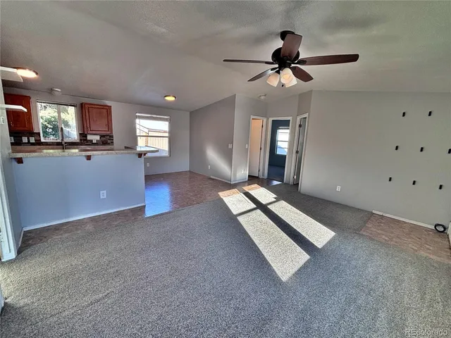 a kitchen with kitchen island granite countertop a sink cabinets and stainless steel appliances