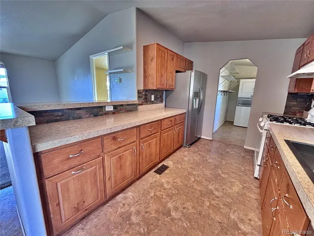 a kitchen with stainless steel appliances granite countertop a sink a stove and a microwave