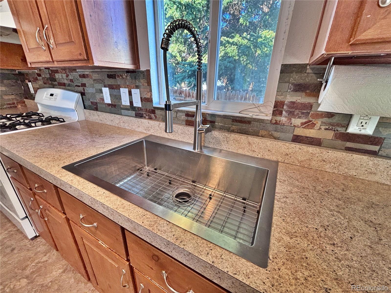 155 A Street Golden, CO 80401 - Photo 21 of 49 a kitchen with stainless steel appliances granite countertop a sink a stove and a microwave