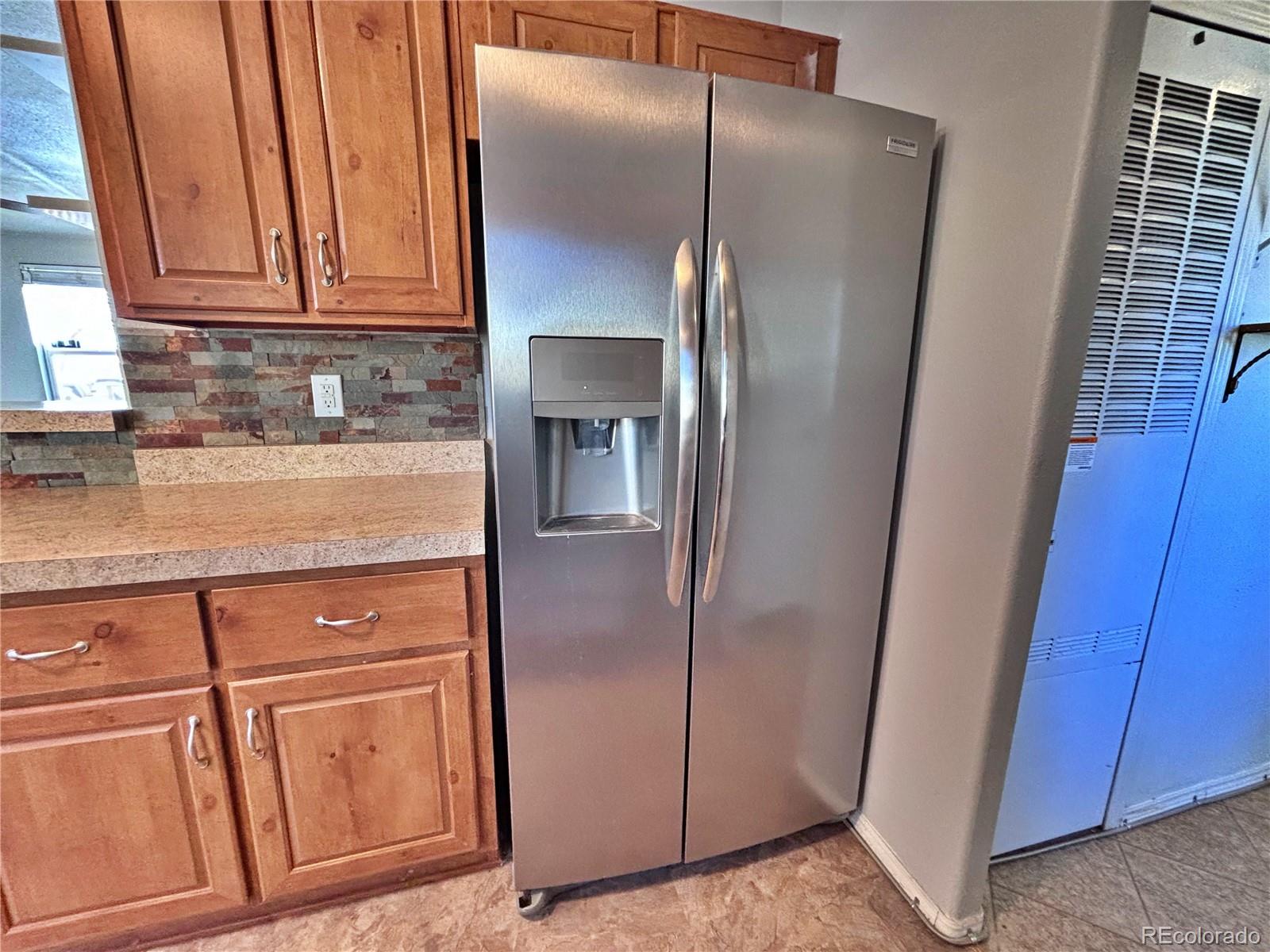 155 A Street Golden, CO 80401 - Photo 24 of 49 a kitchen with metallic refrigerator freezer and a dishwasher with wooden floor