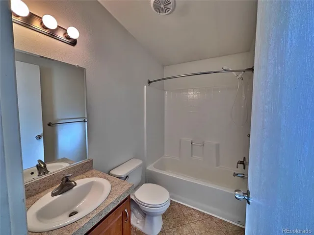 an empty room with windows and entrance