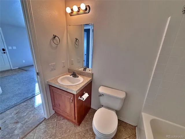 an empty room and chandelier fan