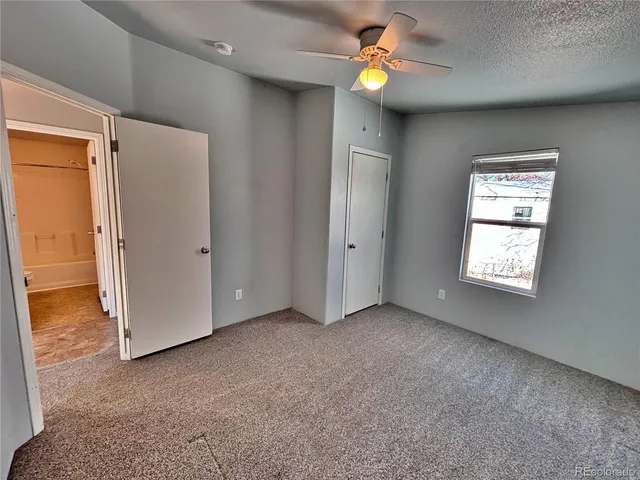 wooden floor with kitchen view and a window