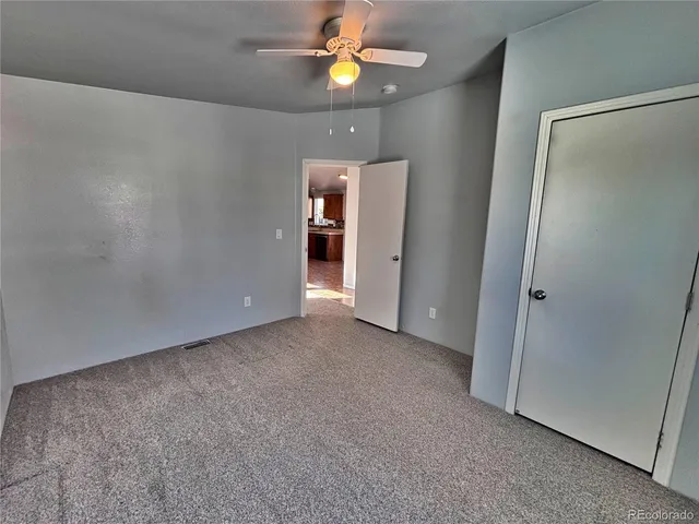 a view of a livingroom with a ceiling fan and window