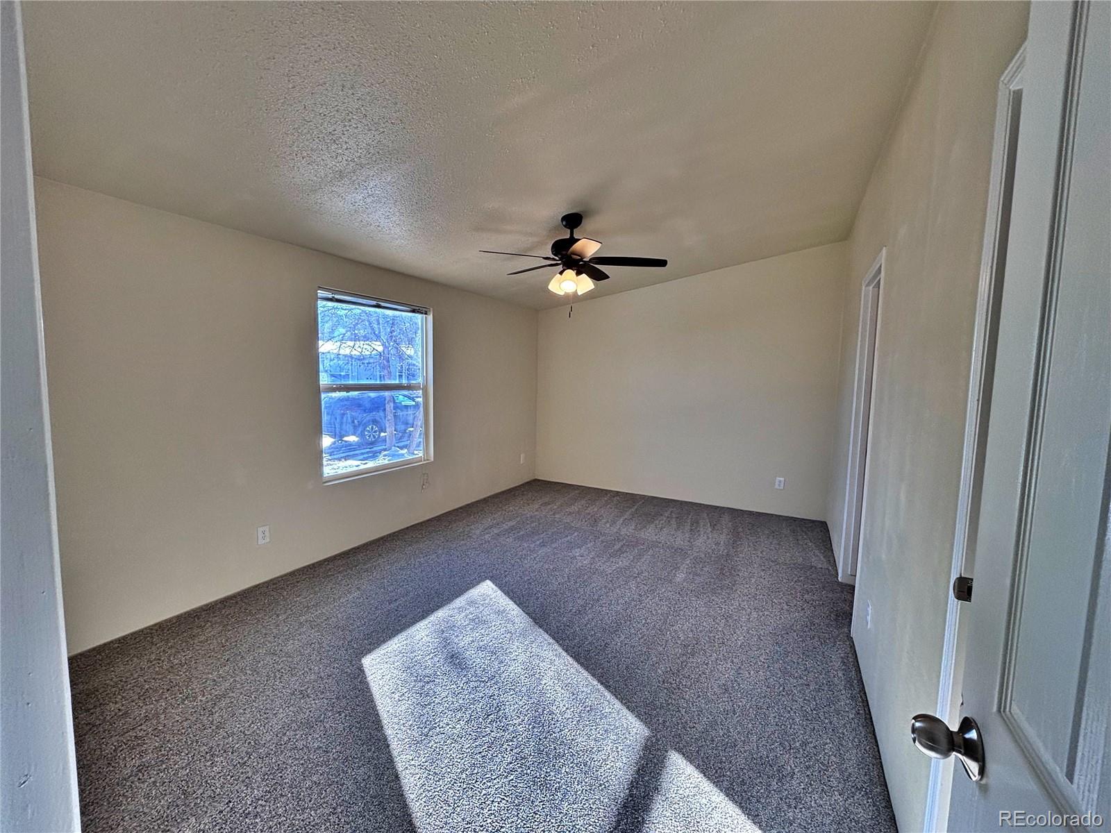155 A Street Golden, CO 80401 - Photo 38 of 49 an empty room with windows and fan