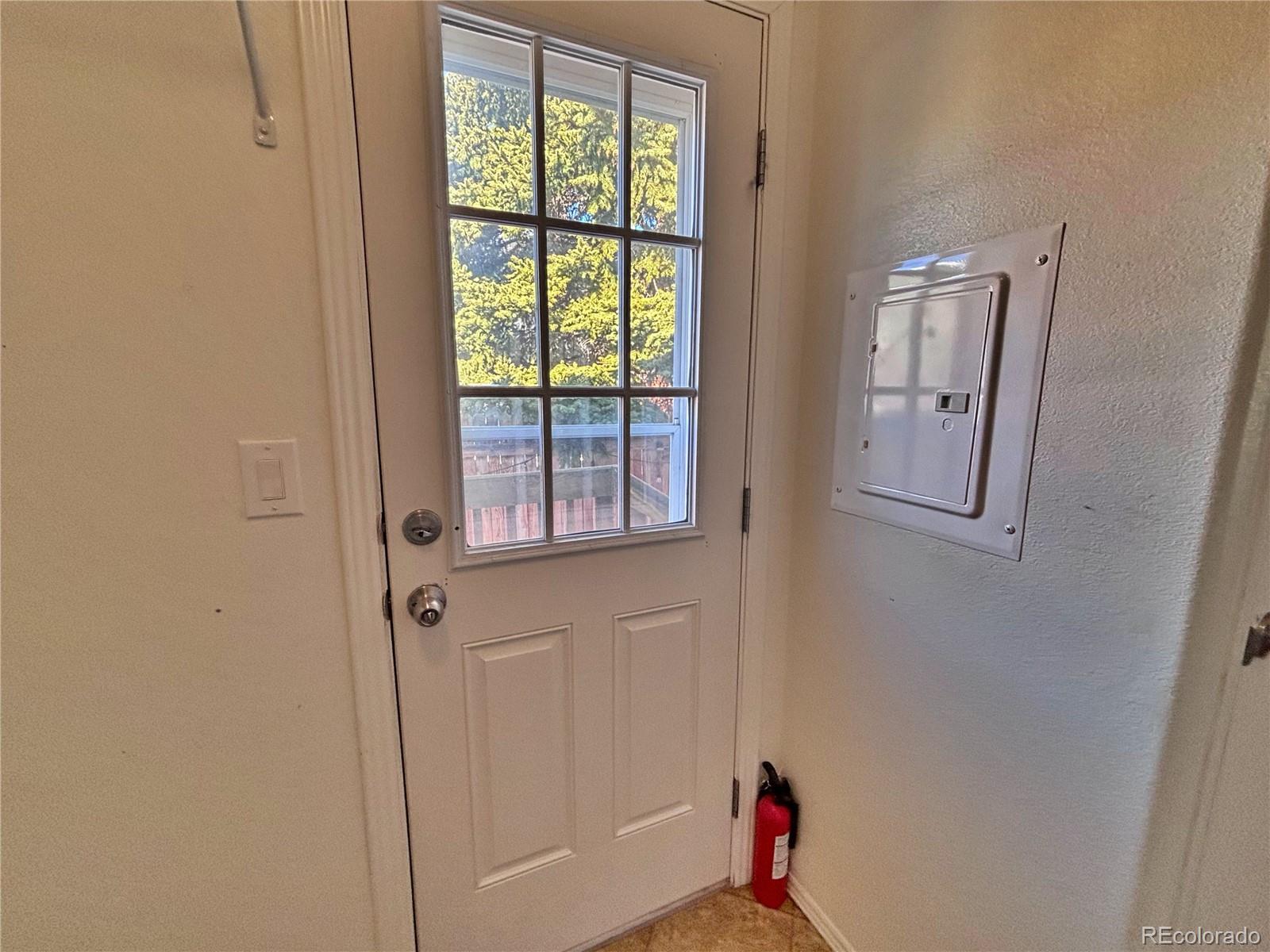 155 A Street Golden, CO 80401 - Photo 43 of 49 a hallway with sliding door and wooden floor