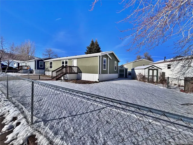 a view of a house with wooden deck front of house