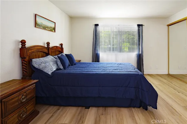a view of room with wooden floor and furniture