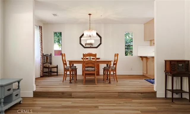 a kitchen with stainless steel appliances wooden floors and wooden cabinets