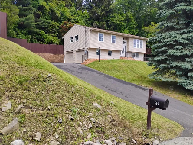 a house that has a tree in front of it