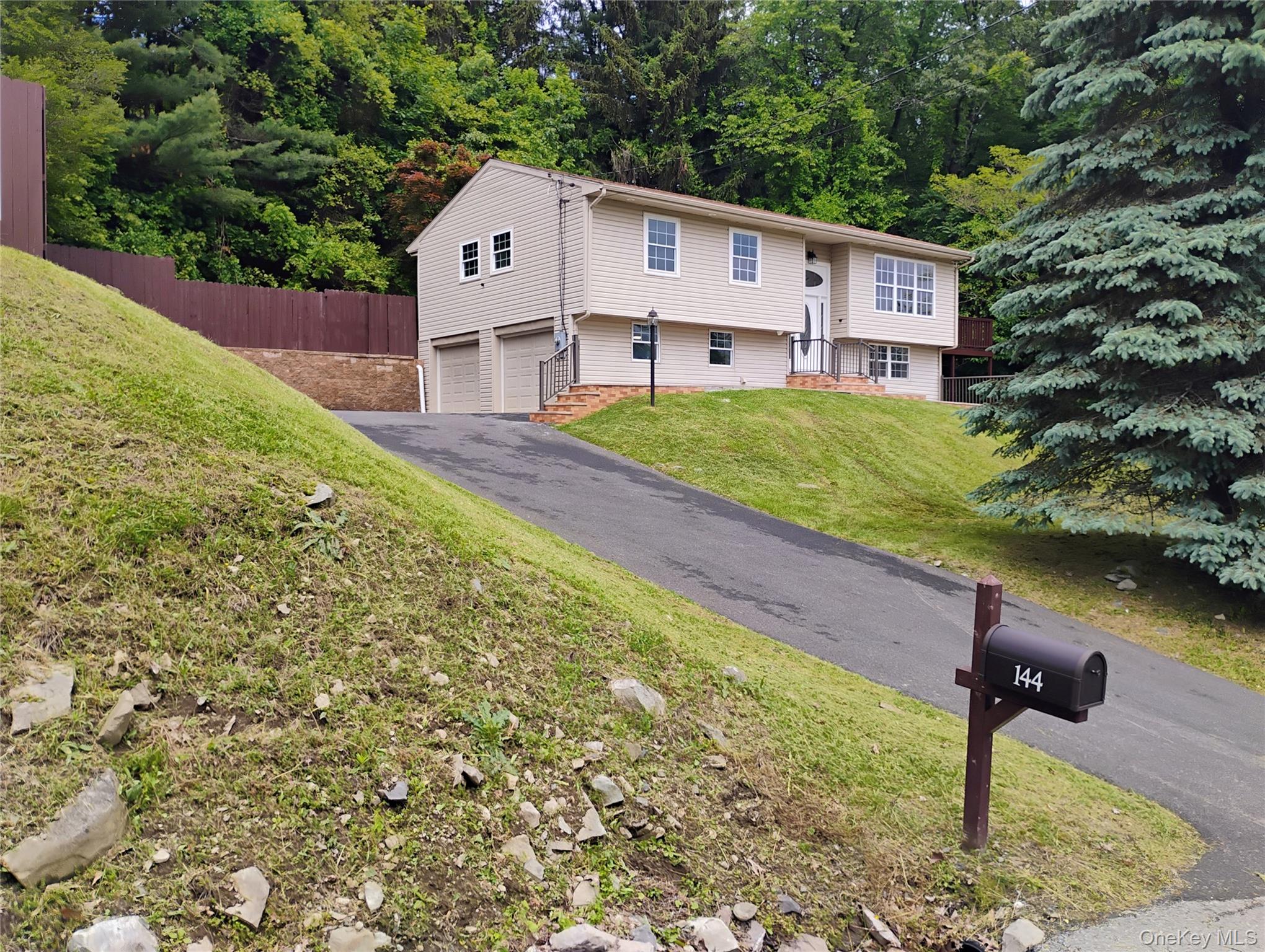 a house that has a tree in front of it