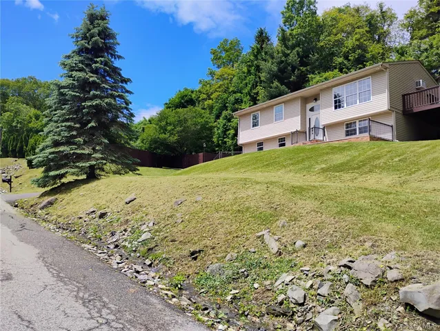 a backyard of a house with a yard and trees