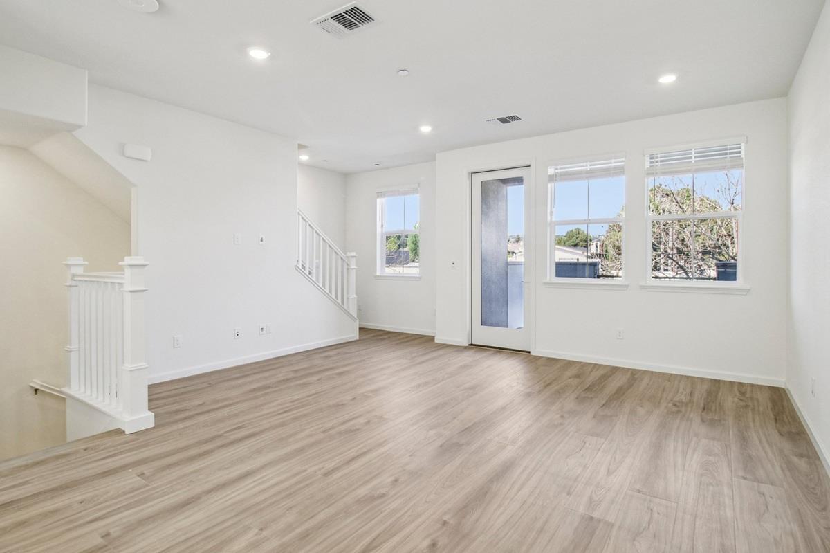 3769 Castro Valley Boulevard Castro Valley, CA 94546 - Photo 8 of 33 an empty room with wooden floor and windows