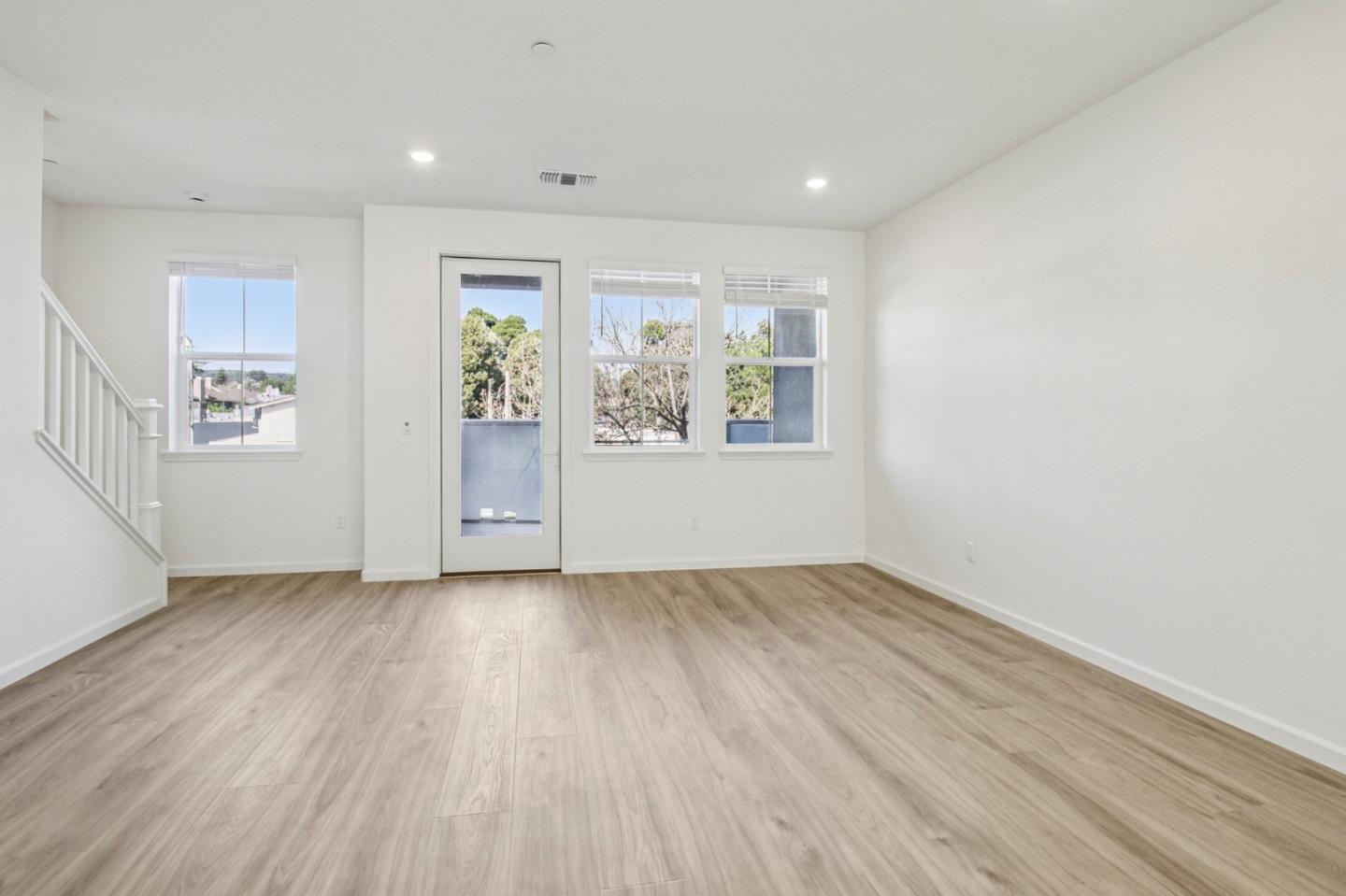 3769 Castro Valley Boulevard Castro Valley, CA 94546 - Photo 9 of 33 an empty room with wooden floor and windows