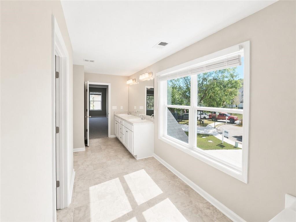 524 Rippling Court Temple, GA 30179 - Photo 16 of 19 a large white kitchen with a large window