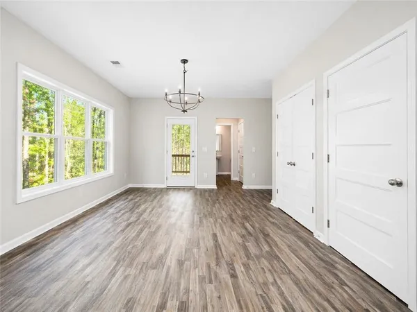 a large kitchen with stainless steel appliances granite countertop a stove a sink dishwasher and a microwave oven with wooden floor