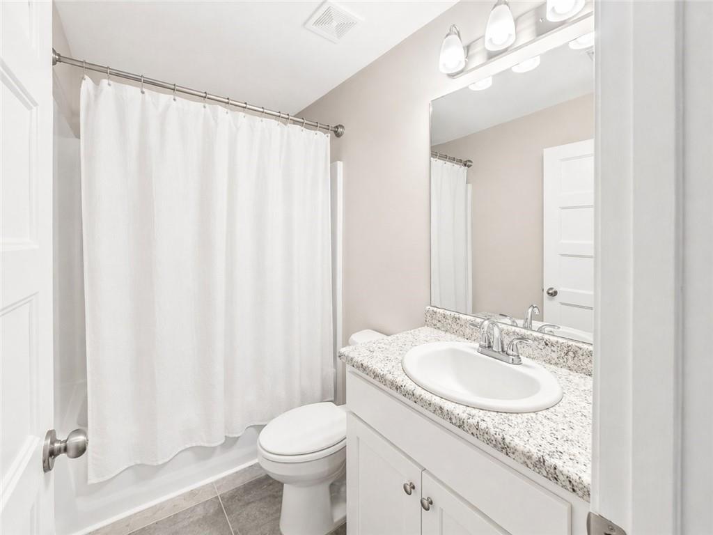 524 Rippling Court Temple, GA 30179 - Photo 6 of 19 a bathroom with a granite countertop sink a toilet and a mirror